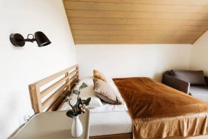 a small bedroom with a bed and a bath tub at Domek pod Szarowym lasem in Wisła