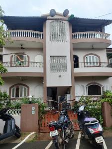 two motorcycles parked in front of a building at Serene Homestay in Panaji
