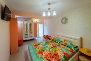 a bedroom with a bed with a flower blanket at Boutique Guest House 'Sofia' in Nesebar
