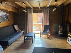 a living room with a couch and a fireplace at Chalet 6A dans les Pyrénées proche d'Andorre in LʼHospitalet-près-lʼAndorre