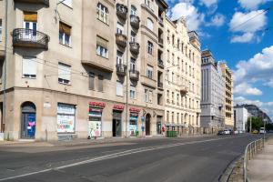 an empty street next to a large building at Luxurious Central Apartment next to the Danube River in Budapest