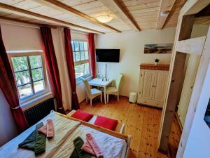 a bedroom with a bed and a desk in a room at Strandhotel Lindequist in Ostseebad Sellin