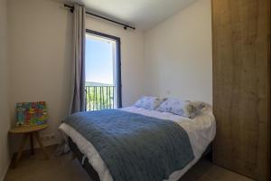 a bedroom with a bed and a large window at Villa Tica in Malaucène +23 photos