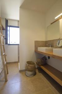 a bathroom with a sink and a mirror at Villa Tica in Malaucène