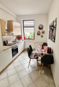 a kitchen with a table and chairs in a kitchen at Ferienwohnung La Finesse in Bad Salzungen