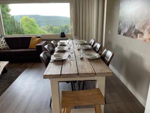 a table with plates and glasses on it in a living room at Apartment Haus Aktiv Panorama in Winterberg