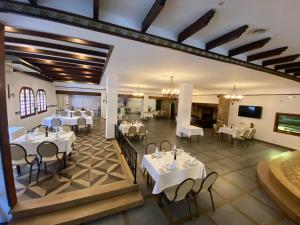 a restaurant with tables and chairs in a room at Hotel Ramis fundado en 1969 in Ondara
