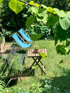 two chairs and a table with a plant on it at Mieszkanko z ogródkiem , między jeziorami in Olsztyn