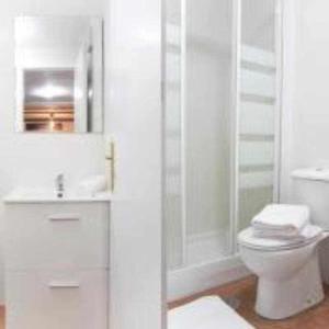 a white bathroom with a toilet and a shower at A Unos Pasos Para Gran Via Madrid Xxl in Madrid