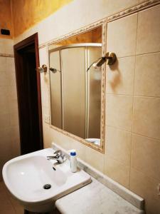 a bathroom with a sink and a mirror at Casa immersa nella natura in Capanne di Sillano