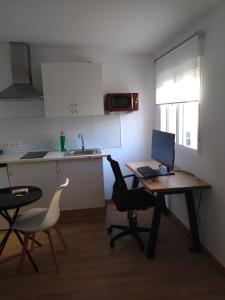 a kitchen with a desk with a laptop computer on it at Appartment as a Service - Lo Mejor en Malaga Centro - Look no Further and Just Book in Málaga