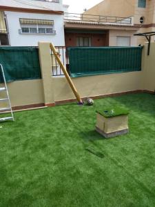 a small backyard with a slide on the grass at Appartment as a Service - Lo Mejor en Malaga Centro - Look no Further and Just Book in Málaga