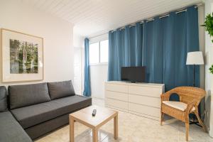 a living room with a couch and a tv at Livramento Residence in Livramento