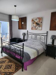a bedroom with a black bed and a window at Contempory exclusive Sitges area in Barcelona