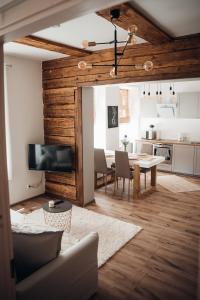 a living room with a table and a kitchen at Stylish and cozy old town apartment in Võru