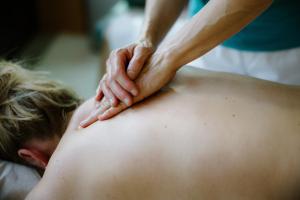 a man getting a back massage from a therapist at Adler Adelboden in Adelboden