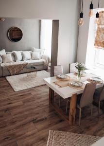 a living room with a table and a couch at Stylish and cozy old town apartment in Võru