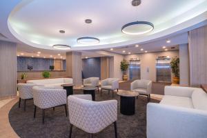 a lobby with chairs and tables and a waiting room at Sandman Hotel Montreal - Longueuil in Longueuil