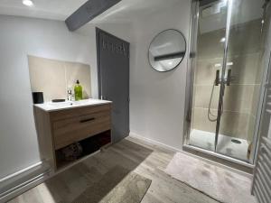 a bathroom with a shower and a sink and a mirror at Kiss Cool - Loft en centre ville in Saint-Dizier