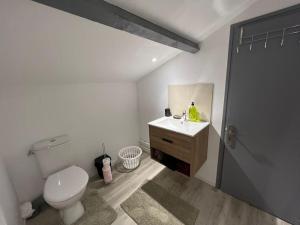 a white bathroom with a toilet and a sink at Kiss Cool - Loft en centre ville in Saint-Dizier
