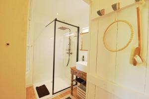 La salle de bains est pourvue d'une douche et d'un lavabo. dans l'établissement La Maisonnette de La Jolie Vie, à Urval