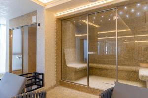 a glass shower in a room with a staircase at W Regal Boutique Hotel&Spa in Mamaia
