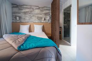 a bedroom with two beds and a large window at Camping Le Calypso 5 étoiles in Torreilles