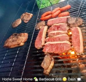 a grill with meat and sausages and other foods at FLiXBEDS - The Man Cave Free Laundry - Parking - Wi-Fi in Fort Lauderdale