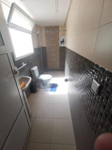 a bathroom with a toilet and a sink at Chatif in Agadir