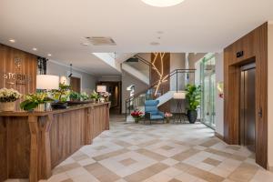 a lobby of a salon with a reception desk and chairs at STORIES Design ApartHotel in Jūrmala