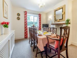 a kitchen and dining room with a table and chairs at Halls Bank Farm in Aspatria