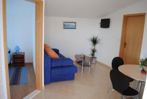 
a living room with a couch and a table at Apartments Kairos - Bili 9 in Kaštela
