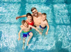 a group of people in a swimming pool at Lovely 6 Berth Caravan At Caldecott Hall Country Park, Norfolk Ref 91010C in Great Yarmouth