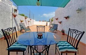 a glass table and chairs on a patio at Gorgeous Home In Ador With Kitchen in Ador