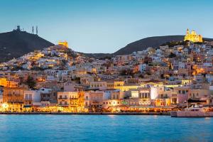 a view of a town on a hill at night at Ano Syros Marvellous oven in Ano Syros
