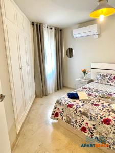 a bedroom with a bed and a window at APARTBEACH SANCHO ABARCA CENTRICO y JUNTO PLAYA in Salou