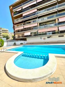 a swimming pool in front of a building at APARTBEACH SANCHO ABARCA CENTRICO y JUNTO PLAYA in Salou