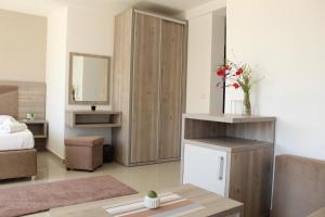 a room with a bedroom with a bed and a mirror at Vista Apartments in Ulcinj +95 photos