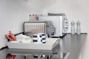 a kitchen counter with a coffee maker and utensils at Thornhill House in Hartlepool