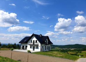 a white house on top of a hill at Zasankowe Wzgórze in Zasań