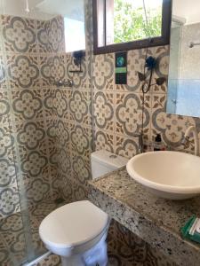 a bathroom with a toilet and a sink at Vilarejo Cipó in Serra do Cipo +77 photos