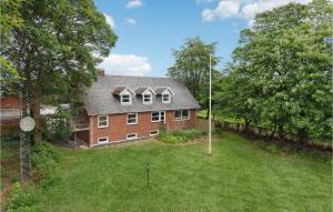 a large red brick house with a yard at Gorgeous Home In Grindsted With Kitchen in Grindsted