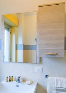 a bathroom with a sink and a mirror at Sea paradise - il mare sotto la finestra in Riposto