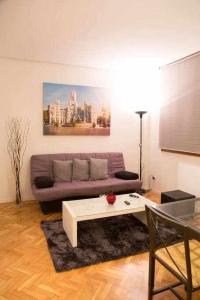 a living room with a couch and a table at Un Elegante Piso Para Descubrir Madrid in Madrid