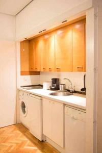 a kitchen with a sink and a washing machine at Un Elegante Piso Para Descubrir Madrid in Madrid