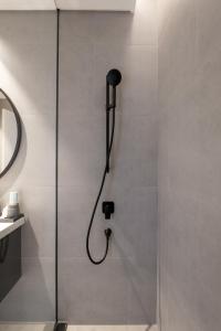 a shower with a shower head in a bathroom at Downtown Ultra Luxury 1BR - 15 Northside - Burj Khalifa View in Dubai