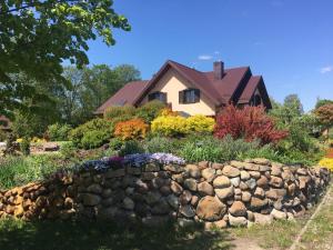 a stone retaining wall in front of a house at Uroczysko Terebiski in Sławatycze