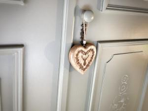 un corazón de madera colgando de una puerta en Gasthof Auwirt en Sankt Michael im Lungau