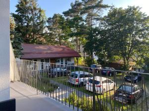 a group of cars parked in a yard behind a fence at Bella Rossi in Jastrzębia Góra