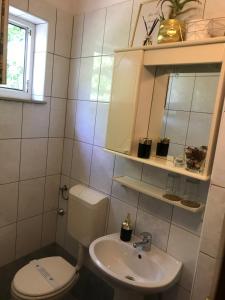 a bathroom with a toilet and a sink at SanMari in Novi Vinodolski